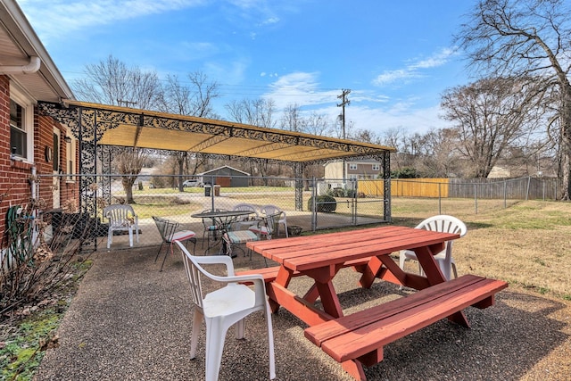 view of patio / terrace with outdoor dining space, fence, and a pergola