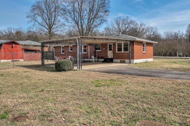 back of house with entry steps, a lawn, and brick siding