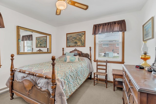 bedroom with baseboards, a ceiling fan, and light colored carpet