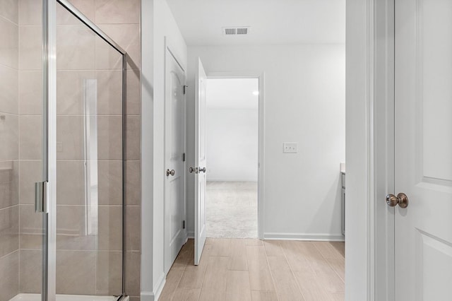 bathroom featuring a stall shower, visible vents, vanity, and baseboards