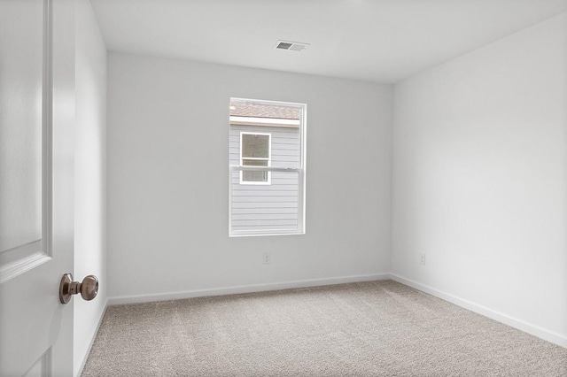 carpeted empty room with baseboards and visible vents