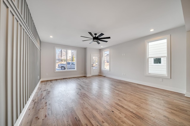 empty room with recessed lighting, ceiling fan, light wood-style flooring, and baseboards