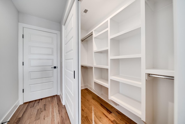 walk in closet featuring visible vents and wood finished floors