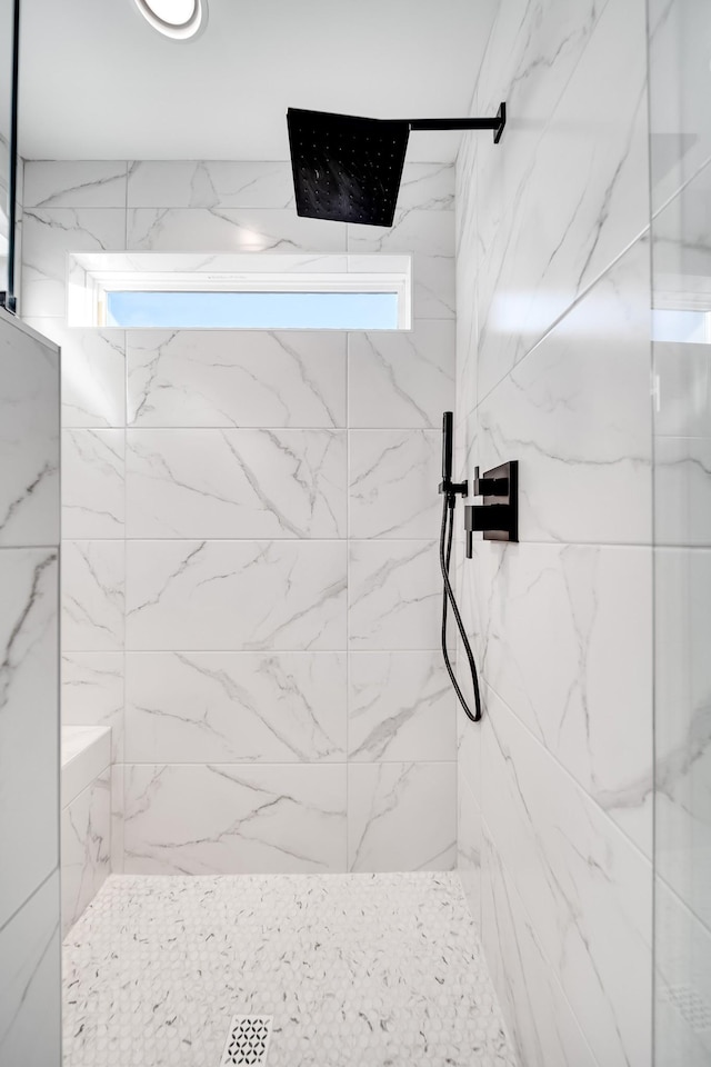 bathroom with a marble finish shower