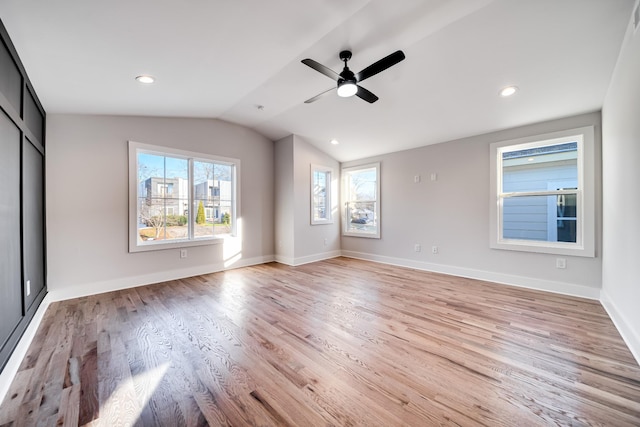 interior space with baseboards, a ceiling fan, vaulted ceiling, light wood-style floors, and recessed lighting