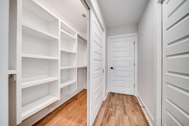 walk in closet with visible vents and light wood finished floors