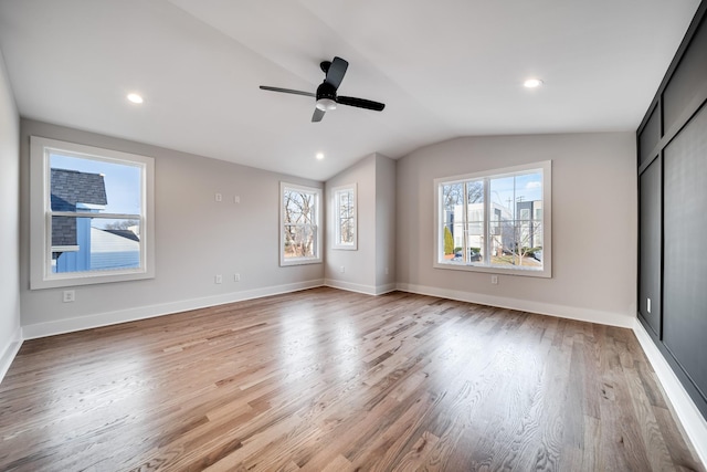 unfurnished bedroom featuring lofted ceiling, light wood finished floors, recessed lighting, and baseboards