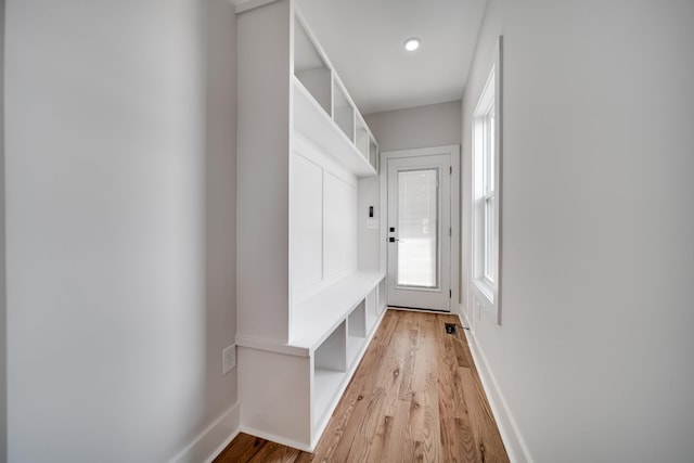 mudroom with light wood finished floors and baseboards