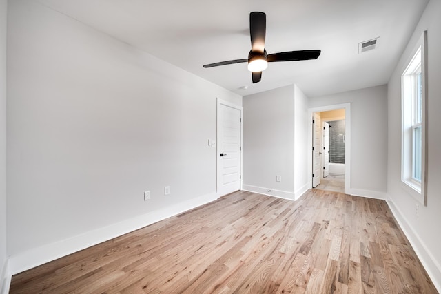 unfurnished bedroom with light wood-style flooring, visible vents, ceiling fan, and baseboards