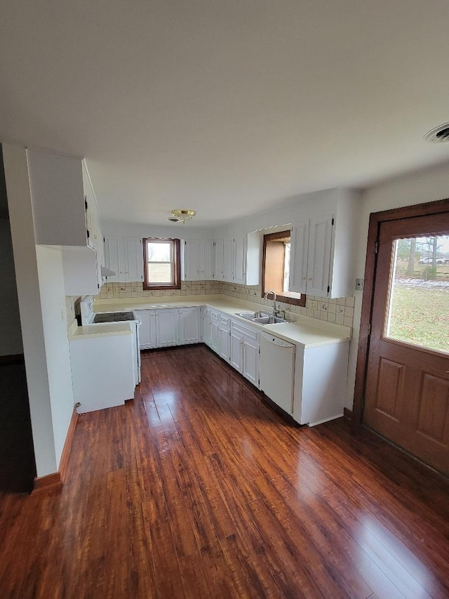 kitchen featuring stove, a sink, white cabinetry, light countertops, and dishwasher