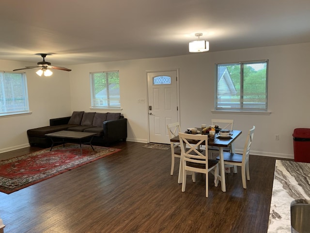 dining room featuring dark wood-type flooring, a ceiling fan, and baseboards