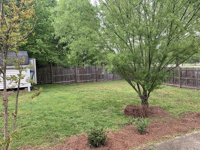 view of yard featuring a storage shed and a fenced backyard