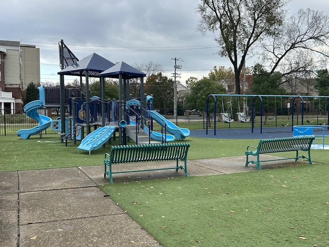 community playground with a yard and fence