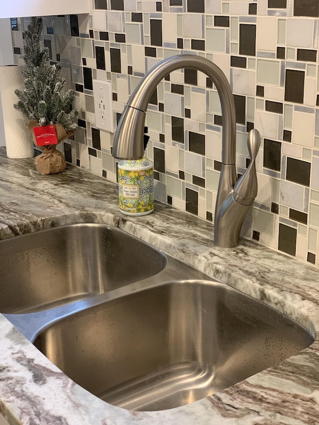 details featuring backsplash and a sink