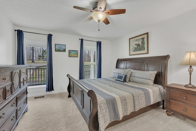 bedroom with a ceiling fan, light carpet, visible vents, and multiple windows