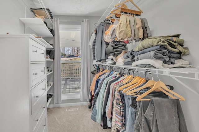 spacious closet with light colored carpet and visible vents