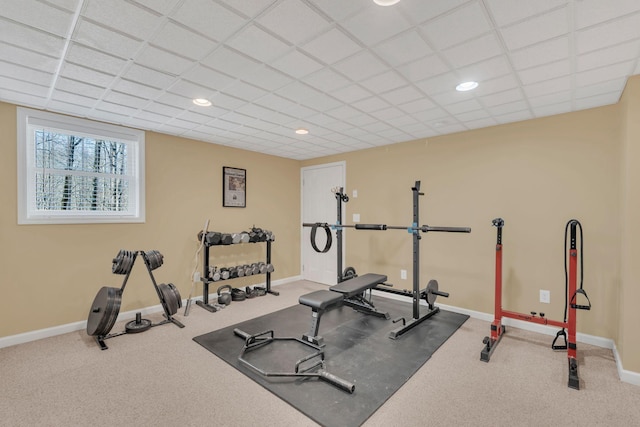 exercise room with carpet floors, baseboards, a drop ceiling, and recessed lighting