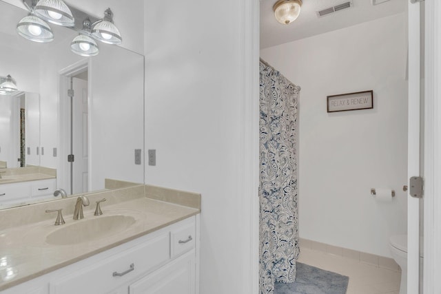 bathroom featuring visible vents, vanity, toilet, and tile patterned floors