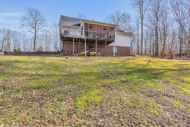 back of house with a ceiling fan, a sunroom, and a yard