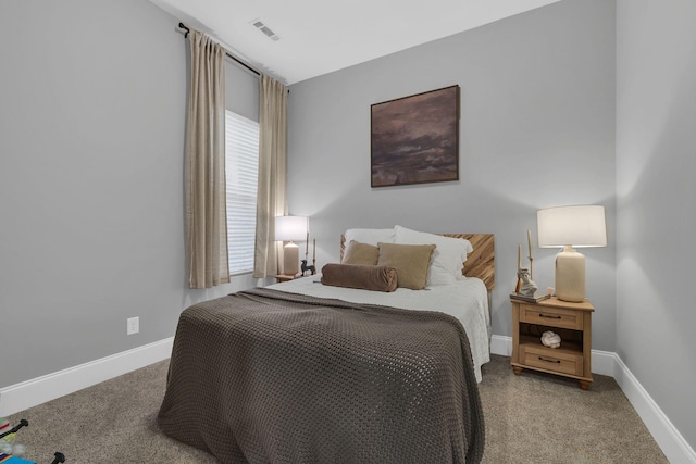 bedroom with carpet, visible vents, and baseboards