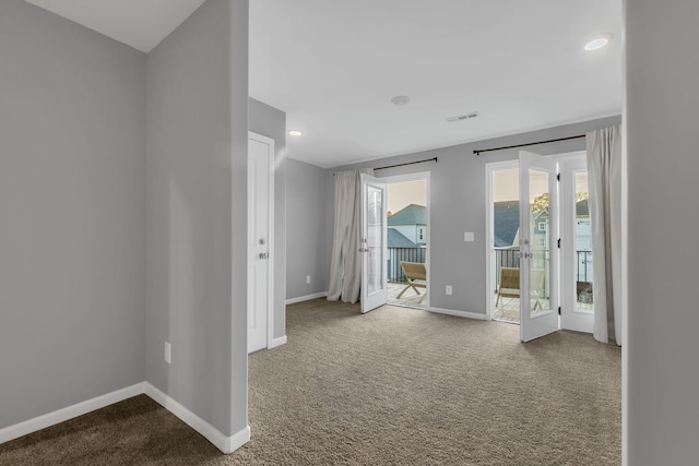 empty room featuring baseboards, visible vents, and carpet flooring