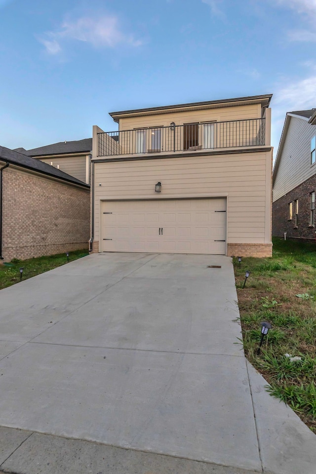 front of property with driveway and a balcony