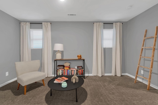 sitting room featuring baseboards, visible vents, and carpet flooring