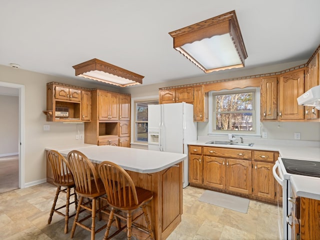 kitchen featuring white appliances, a sink, a kitchen bar, and open shelves