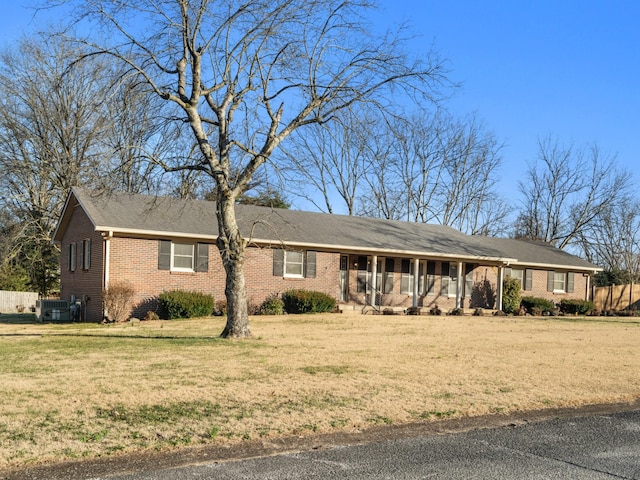 single story home with brick siding and a front yard