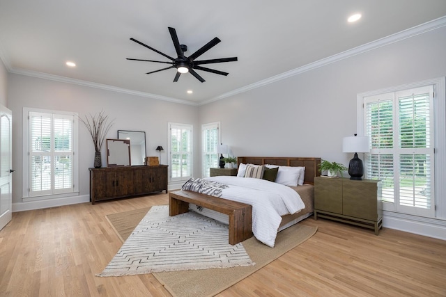 bedroom with multiple windows, crown molding, and light wood-style flooring