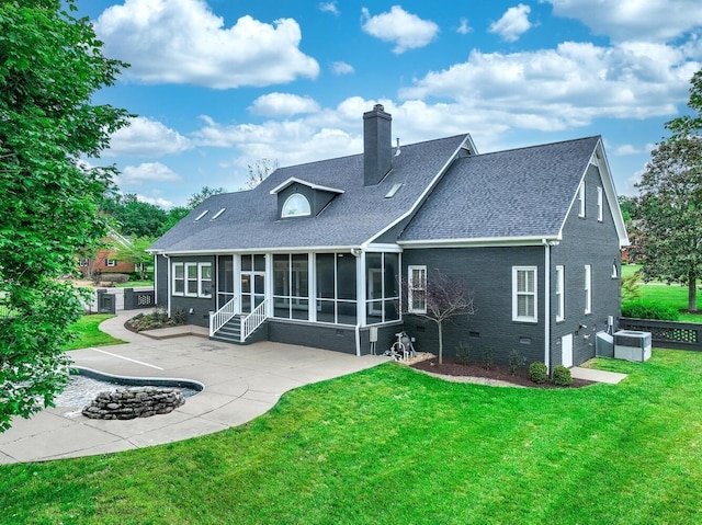 back of property featuring a lawn, a patio, a sunroom, a chimney, and crawl space