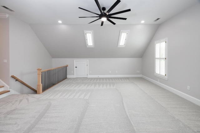 additional living space featuring light carpet, baseboards, visible vents, and recessed lighting