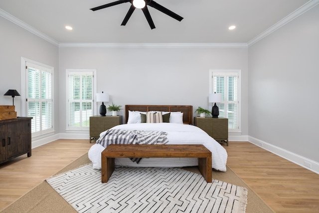 bedroom with light wood-style flooring, ornamental molding, ceiling fan, and baseboards