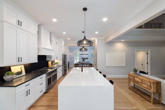 kitchen with pendant lighting, stainless steel appliances, custom exhaust hood, and white cabinets