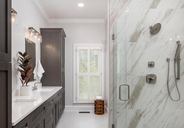 bathroom featuring a sink, visible vents, baseboards, ornamental molding, and a marble finish shower