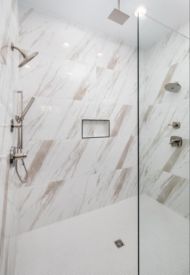 full bathroom with a marble finish shower