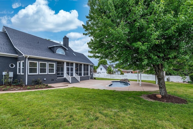 rear view of house with a patio area, a fenced backyard, a sunroom, and a fenced in pool