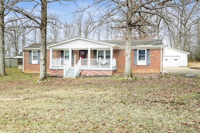 view of front facade with covered porch, brick siding, a front lawn, and a garage