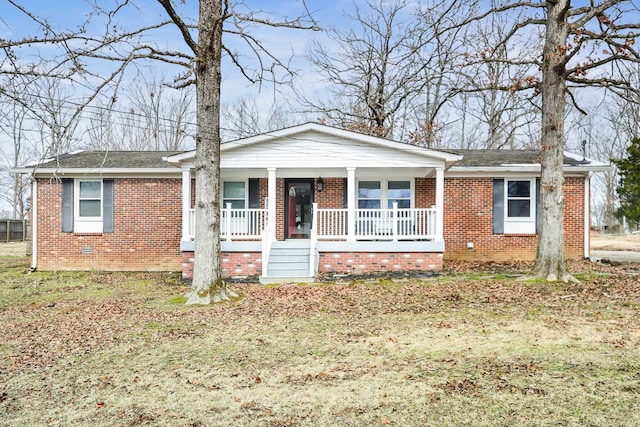 ranch-style house featuring crawl space, a porch, a front lawn, and brick siding