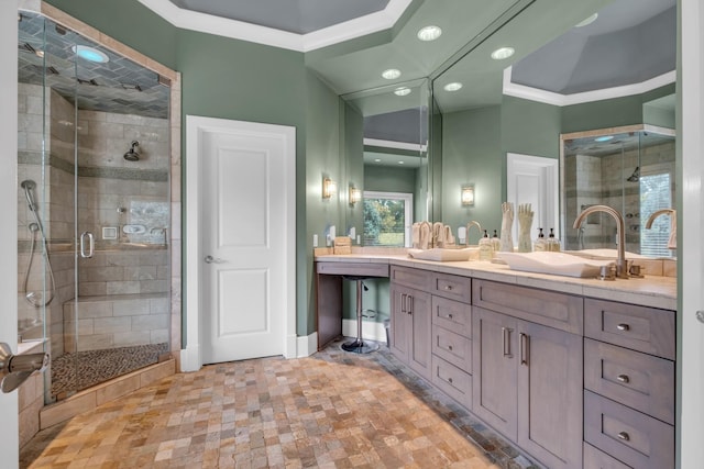 full bath with crown molding, a sink, a shower stall, and double vanity