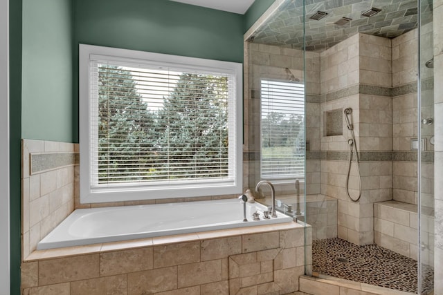 bathroom with a garden tub and a stall shower