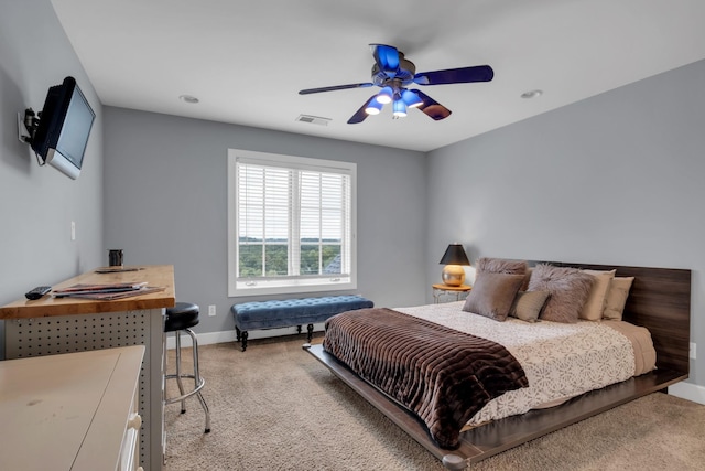 bedroom featuring light carpet, a ceiling fan, visible vents, and baseboards