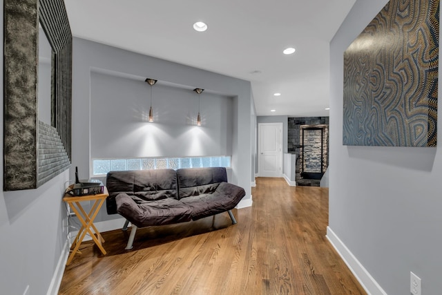 living room featuring recessed lighting, wood finished floors, and baseboards