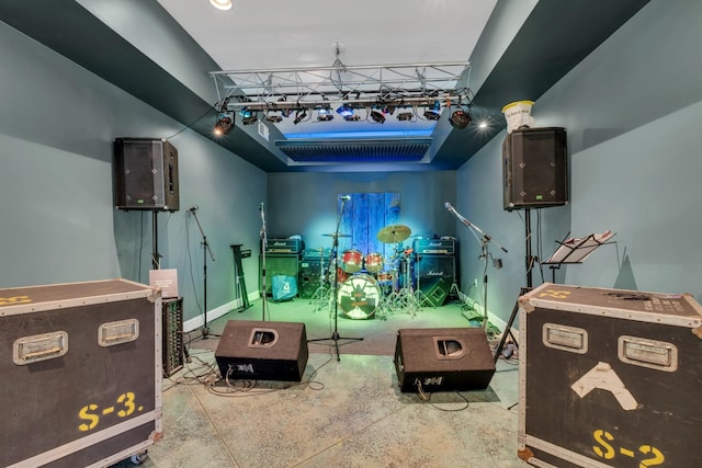 playroom with concrete flooring and baseboards