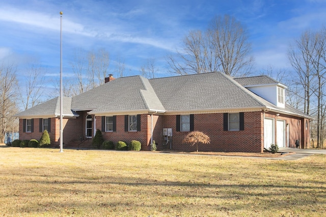 view of front of property featuring a garage, a front yard, brick siding, and driveway