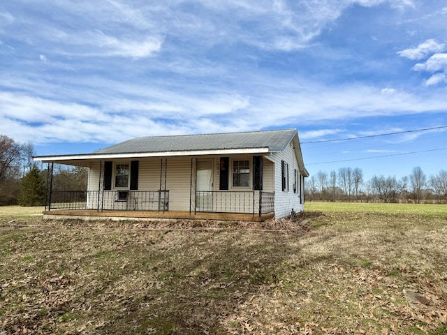 view of front of house with covered porch and metal roof