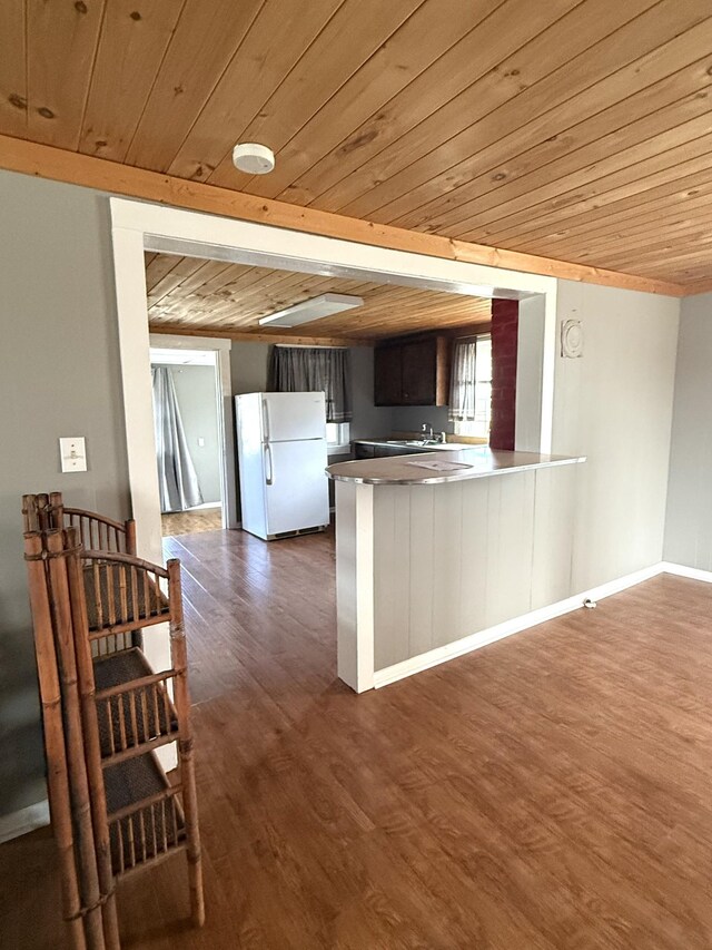 237 County Farm Rd, Ethridge, TN 38456 - kitchen featuring dark wood finished floors, wood ceiling, freestanding refrigerator, a peninsula, and a sink