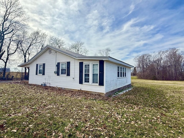 view of side of property with a lawn