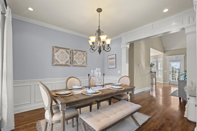 dining room featuring ornamental molding, dark wood finished floors, and decorative columns