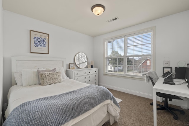 carpeted bedroom featuring visible vents and baseboards